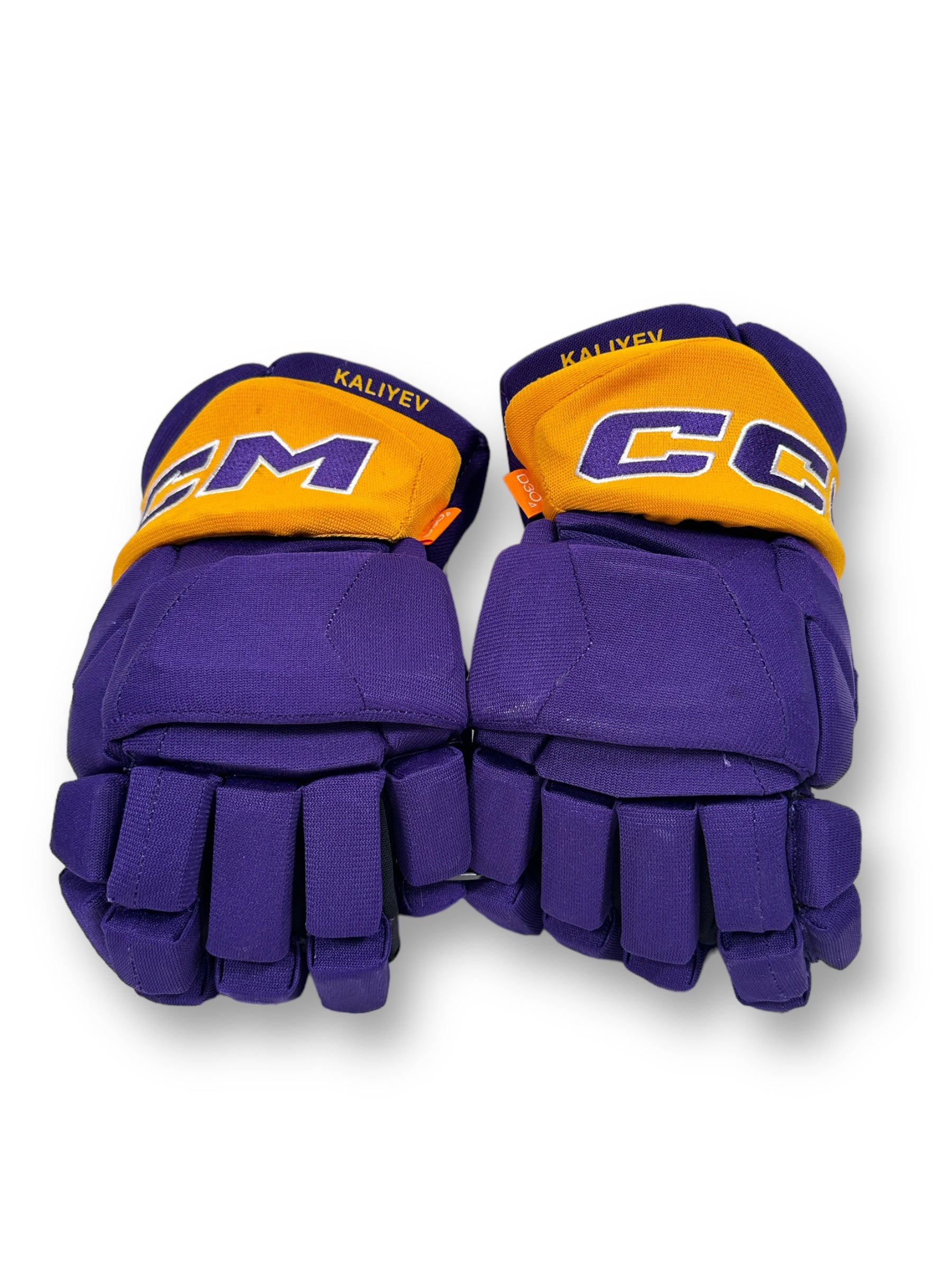 CCM branded gloves, colored forum blue, with a gold cuff, with "Kaliyev" printed on the cuff.
