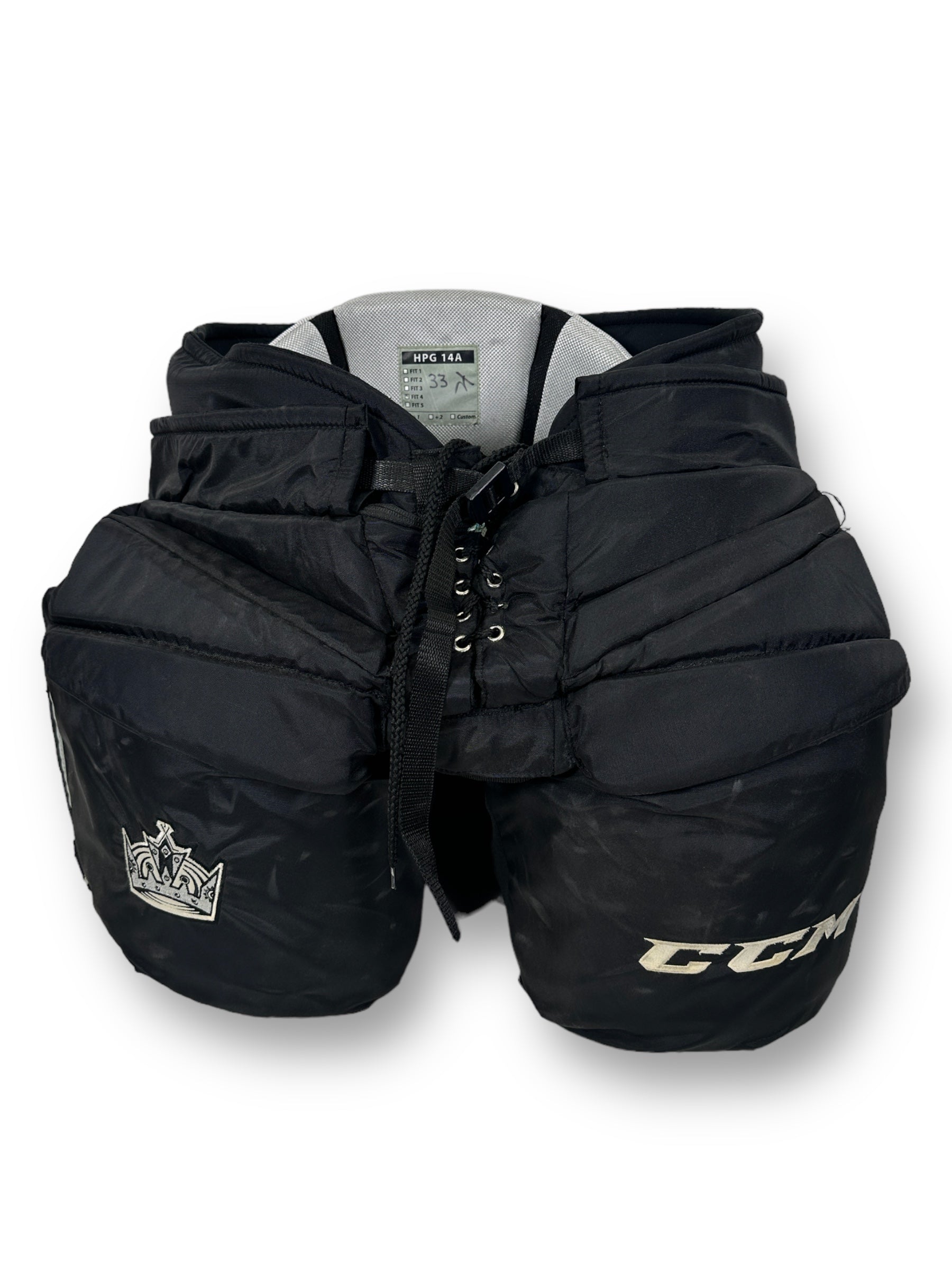 Black goalie pants with signs of wear. Embroidered on the left leg is "CCM" and on the right the Kings crown logo.