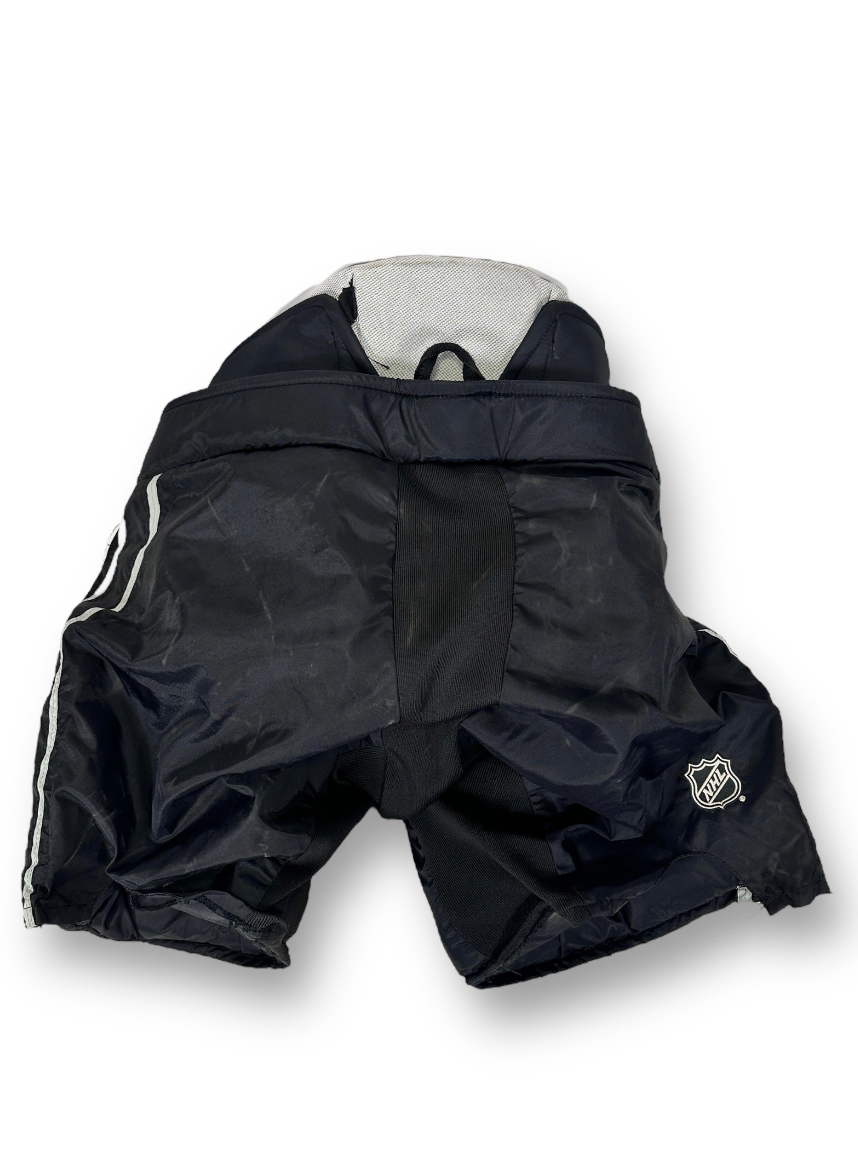 Back side of the goalie pants. On the sides are two silver stripes, and on the back of the right leg is the NHL shield.
