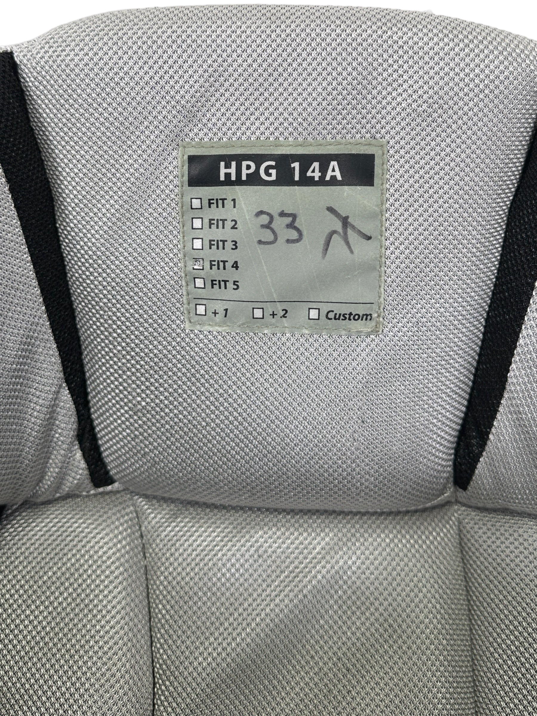 Label marking Fit 4 (XL), with the model HPG 14A, with 33 written on the tag for Lukas Parik, and initialed by Kay Whitmore