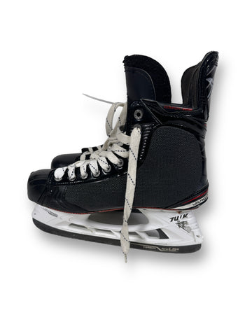 View of the exterior of the left skate, with a view of the shot-blocker. On the blade holders are puck marks on the heel and a smaller mark near the toe