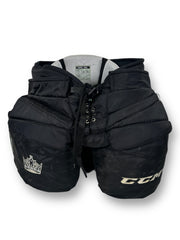 Black goalie pants with signs of wear. Embroidered on the left leg is "CCM" and on the right the Kings crown logo.